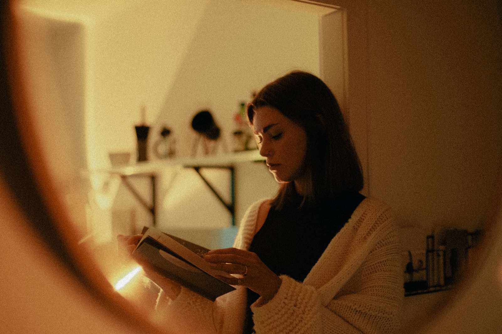 woman in white sweater using tablet computer
